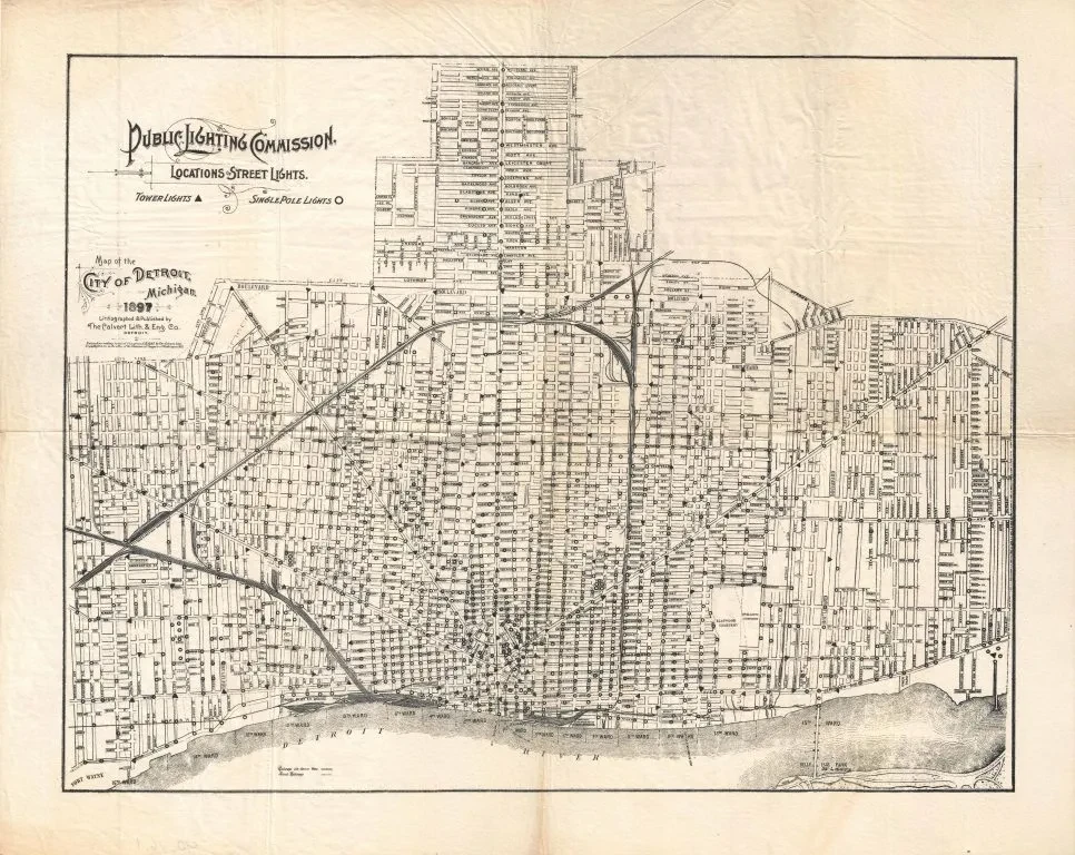 Vintage map of Detroit showing detailed street layout and city blocks, with arching streetcars and transportation lines.